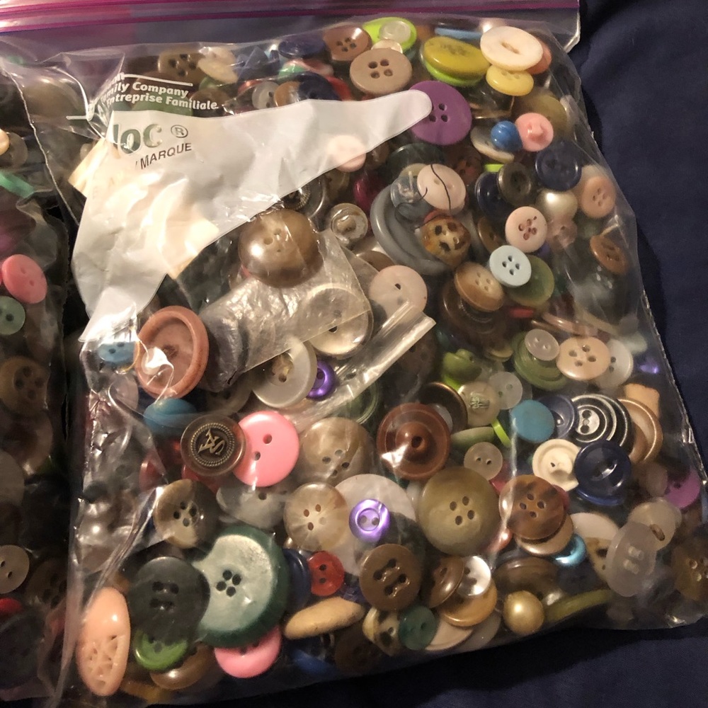 Lot of two quart size bags of buttons. One full and one a little over half full